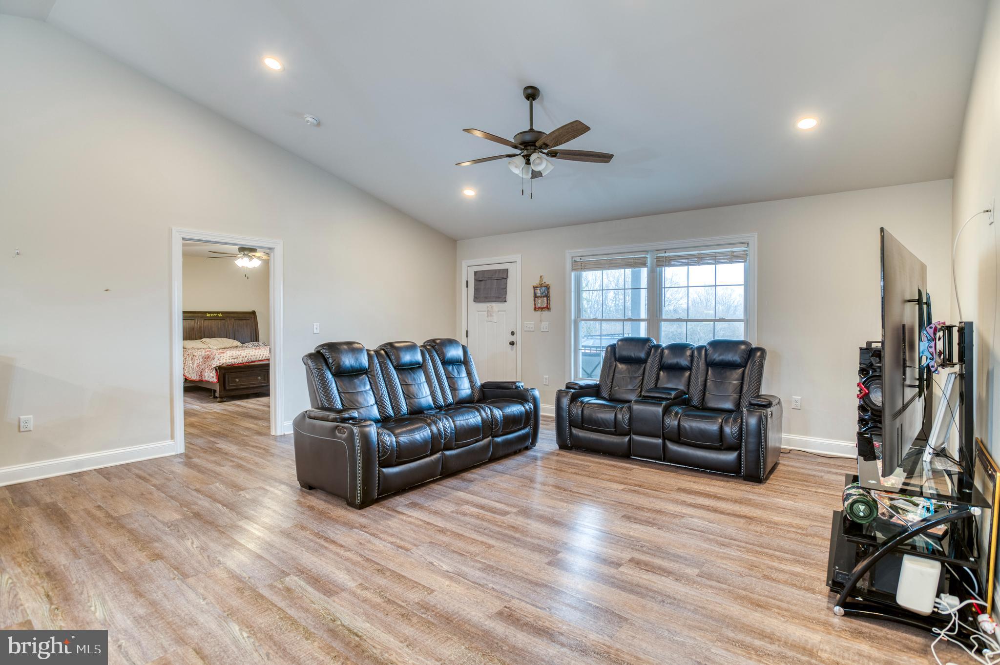 13084 Stonehouse Mountain Road Culpeper, VA 22701 - Photo 2 of 37 a living room with furniture and a flat screen tv