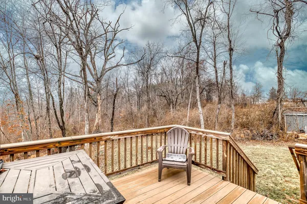 a view of balcony with wooden floor and fence