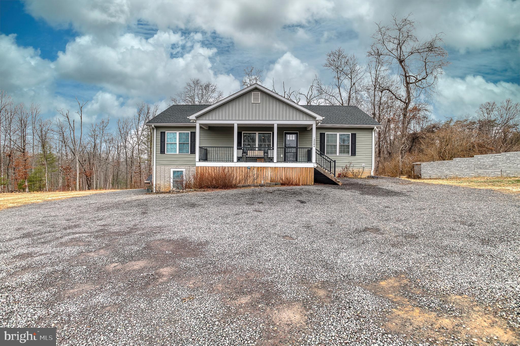 13084 Stonehouse Mountain Road Culpeper, VA 22701 - Photo 23 of 37 a front view of a house with a yard and large trees