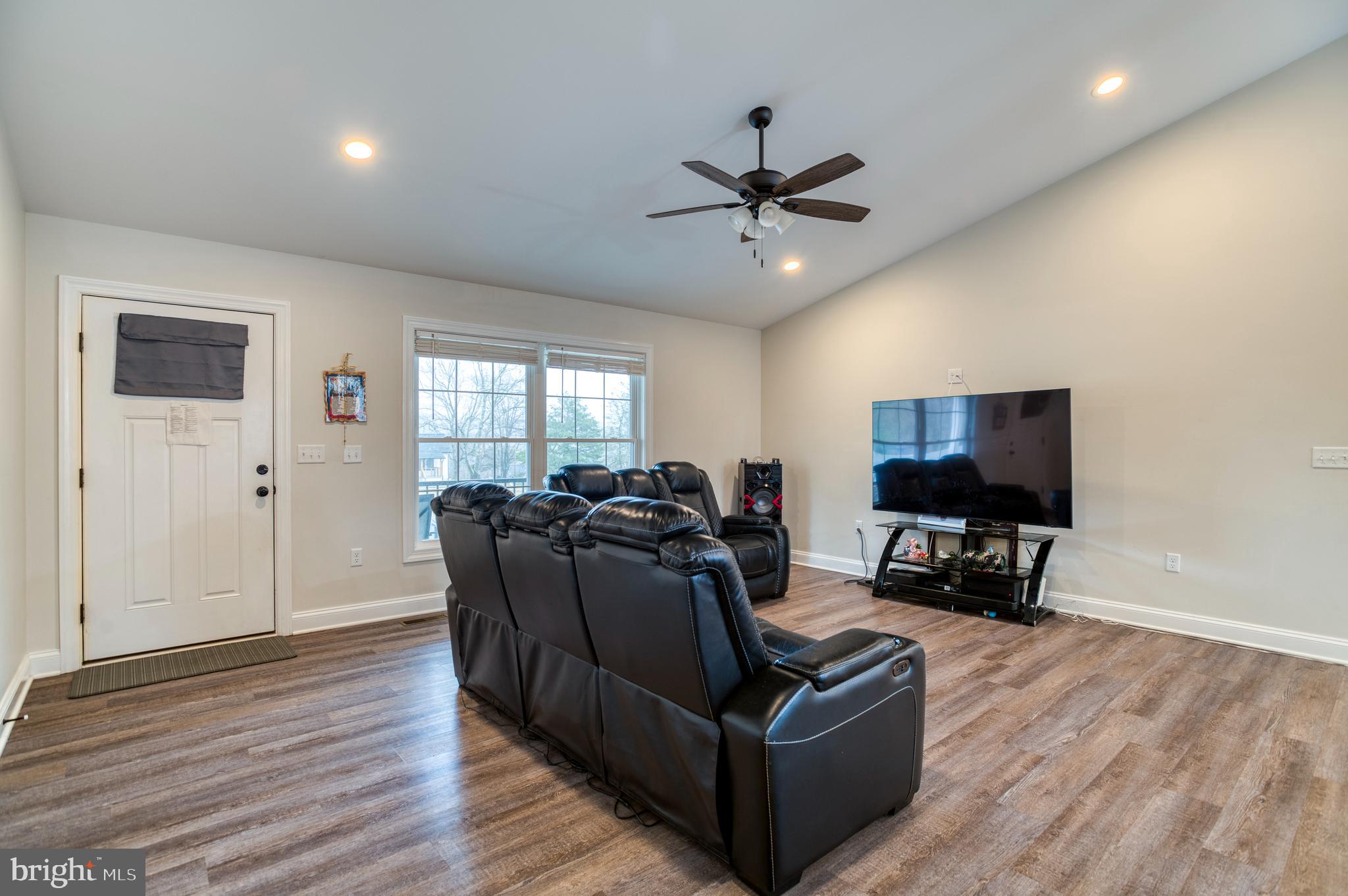 13084 Stonehouse Mountain Road Culpeper, VA 22701 - Photo 3 of 37 a living room with furniture and a flat screen tv