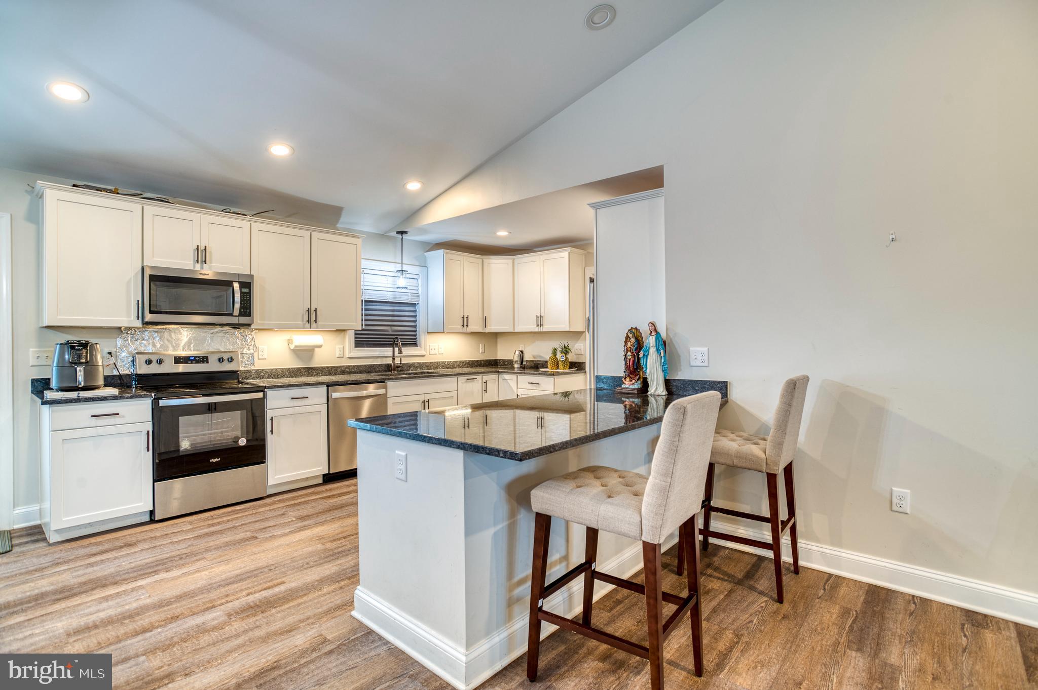 13084 Stonehouse Mountain Road Culpeper, VA 22701 - Photo 6 of 37 a kitchen with a table chairs microwave and cabinets