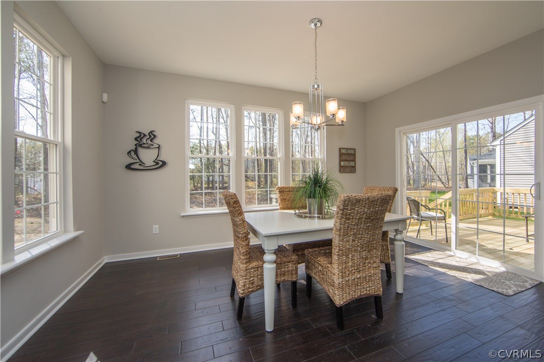 8955 Lavenham Loop Midlothian, VA 23112 - Photo 13 of 47 a view of a dining room with furniture window and wooden floor