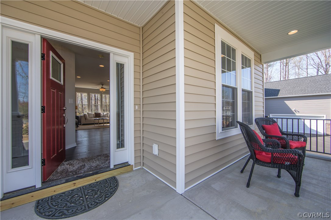 8955 Lavenham Loop Midlothian, VA 23112 - Photo 2 of 47 a view of a porch with a table and chairs