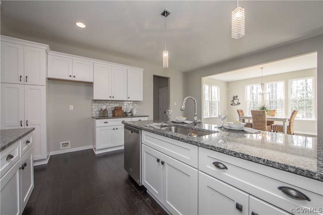 8955 Lavenham Loop Midlothian, VA 23112 - Photo 21 of 47 a kitchen with granite countertop white cabinets and white appliances