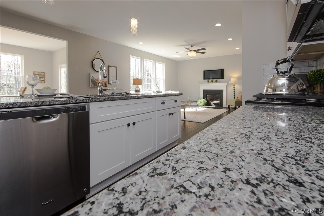 8955 Lavenham Loop Midlothian, VA 23112 - Photo 22 of 47 a large kitchen with stainless steel appliances kitchen island granite countertop a sink and cabinets