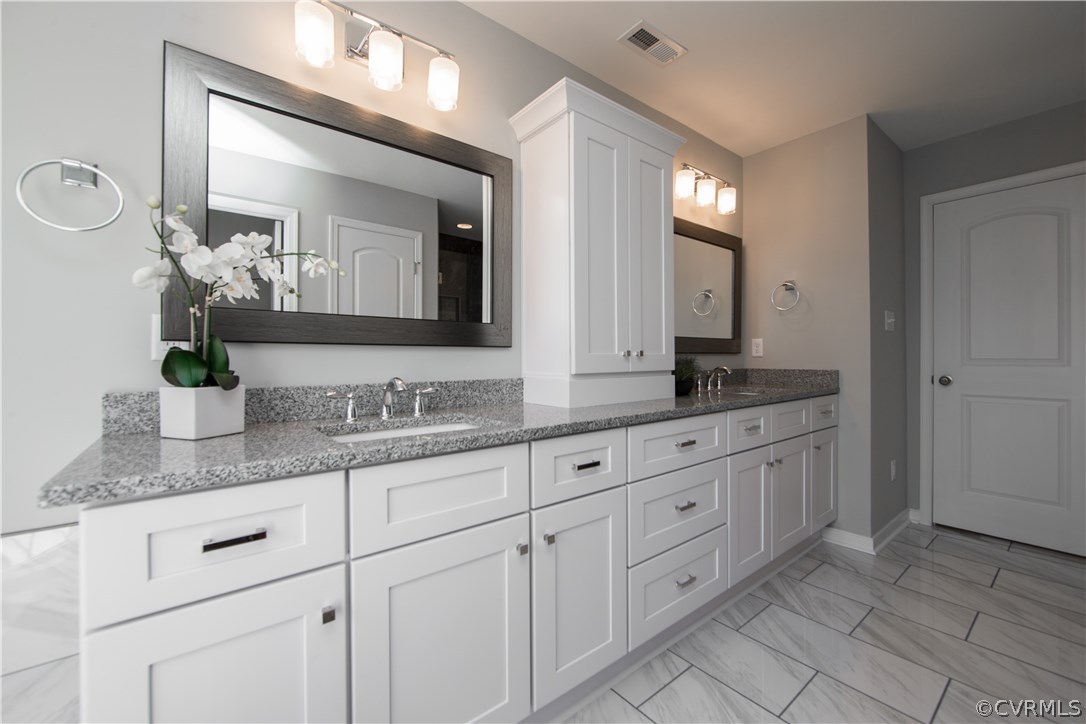 8955 Lavenham Loop Midlothian, VA 23112 - Photo 36 of 47 a bathroom with double sink and a mirror