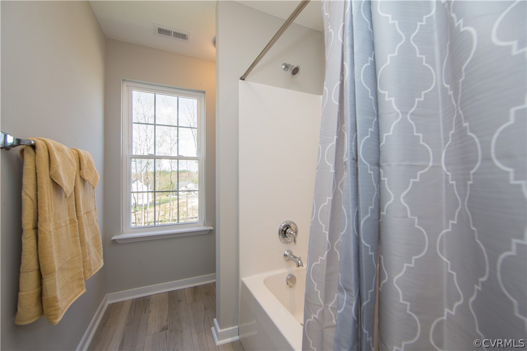 8955 Lavenham Loop Midlothian, VA 23112 - Photo 40 of 47 a bathroom with a bathtub and window