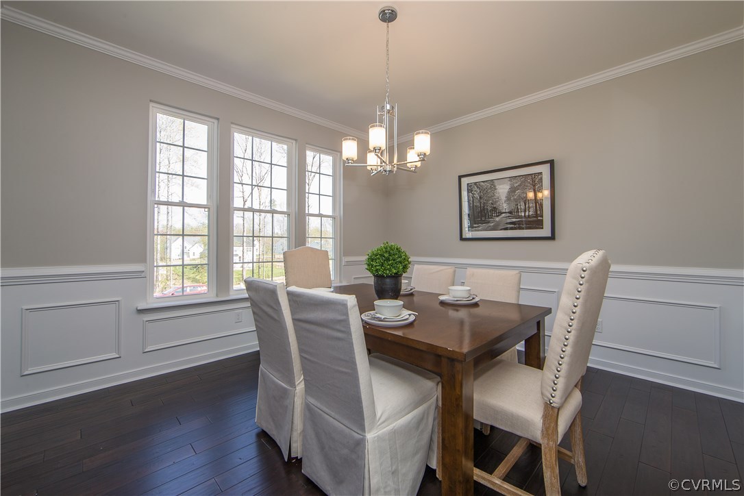 8955 Lavenham Loop Midlothian, VA 23112 - Photo 7 of 47 a dining room with furniture a chandelier and wooden floor
