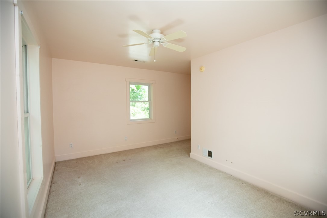 1771 Saw Mill Road Farmville, VA 23901 - Photo 29 of 48 an empty room with a chandelier fan and windows