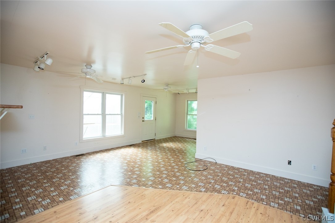 1771 Saw Mill Road Farmville, VA 23901 - Photo 8 of 48 an empty room with wooden floor fan and windows