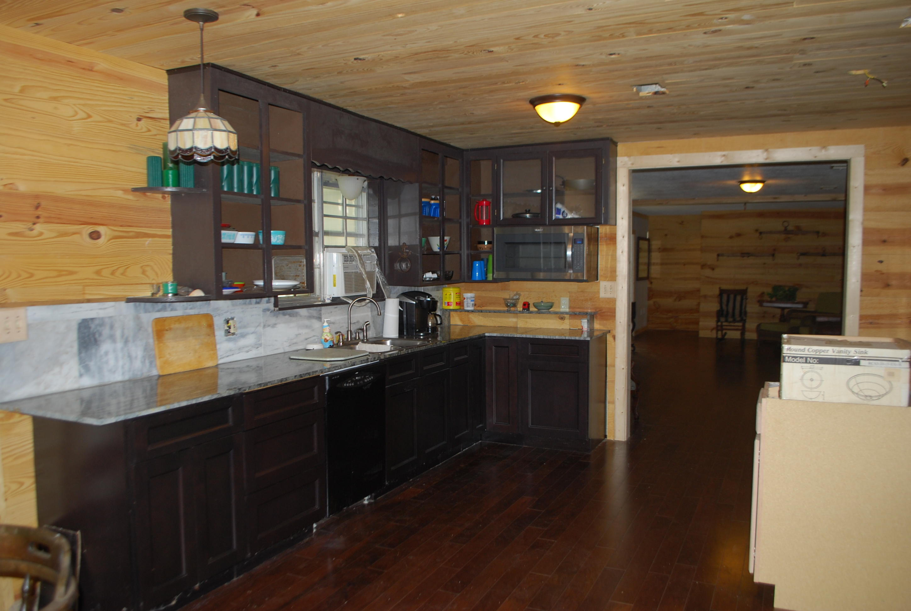 3602 Poverty Creek Road Crestview, FL 32539 - Photo 17 of 29 a kitchen with stainless steel appliances granite countertop a refrigerator a sink dishwasher and wooden cabinets with wooden floor