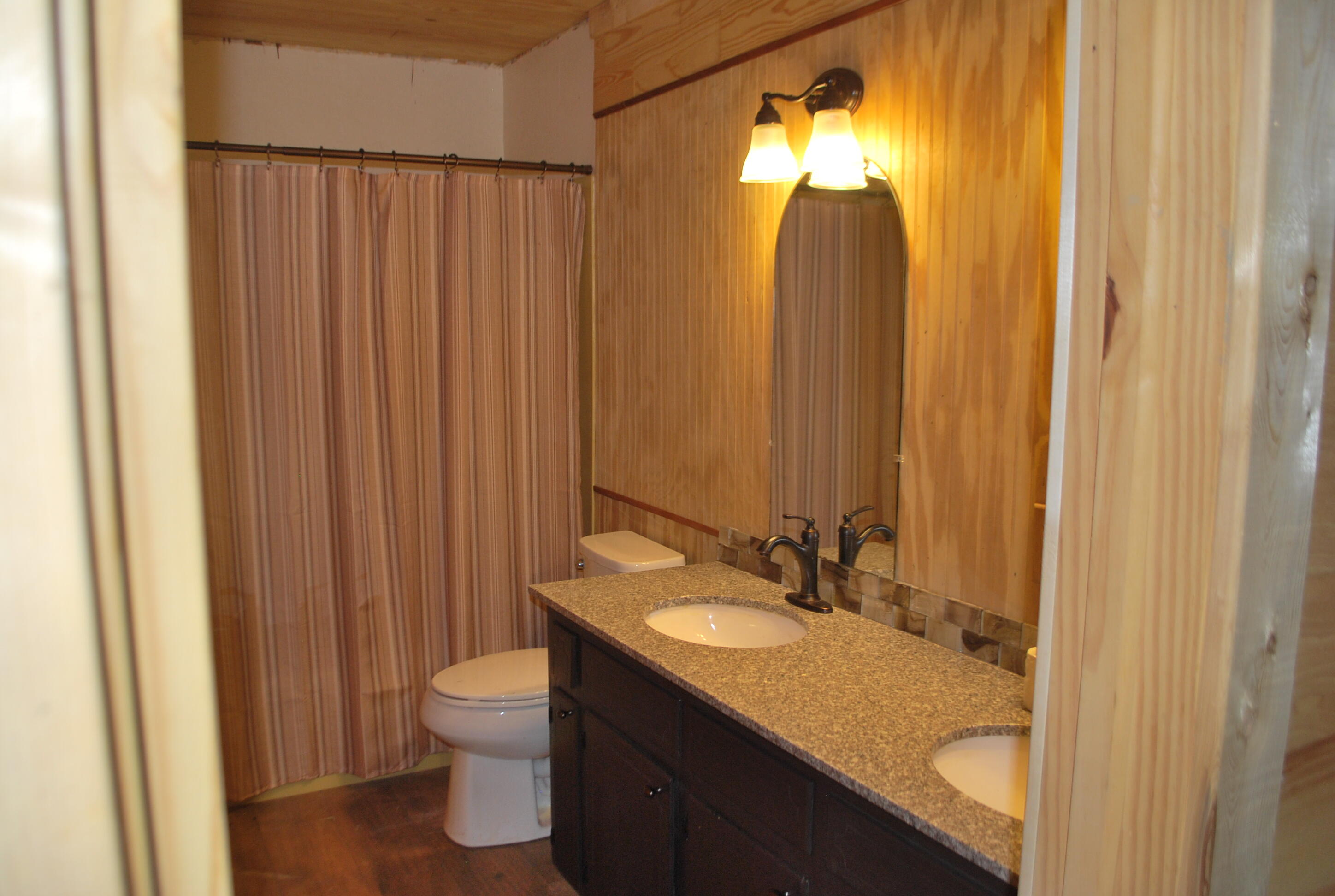 3602 Poverty Creek Road Crestview, FL 32539 - Photo 20 of 29 a bathroom with a granite countertop sink toilet and shower