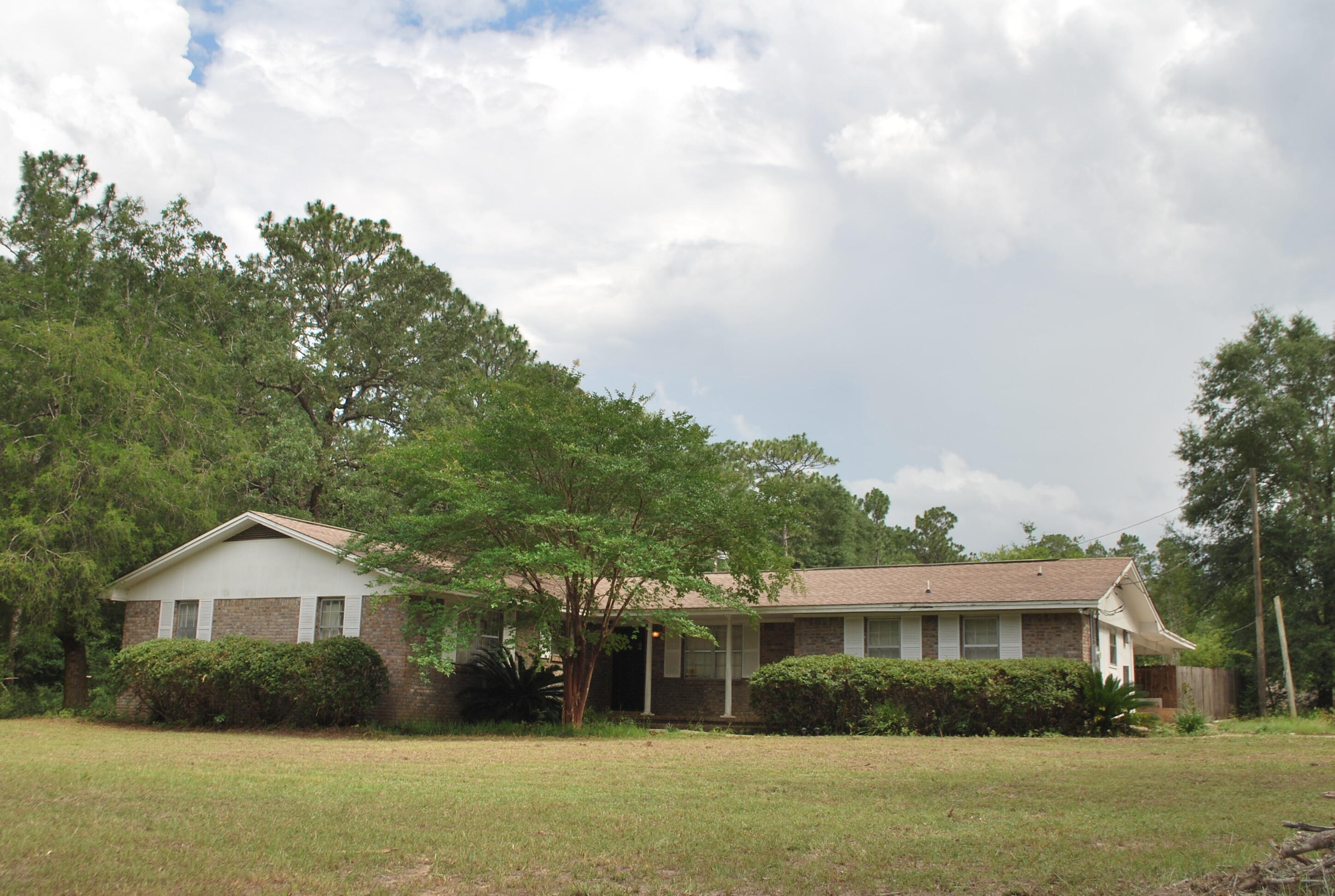 3602 Poverty Creek Road Crestview, FL 32539 - Photo 2 of 29 a front view of a house with a yard and trees