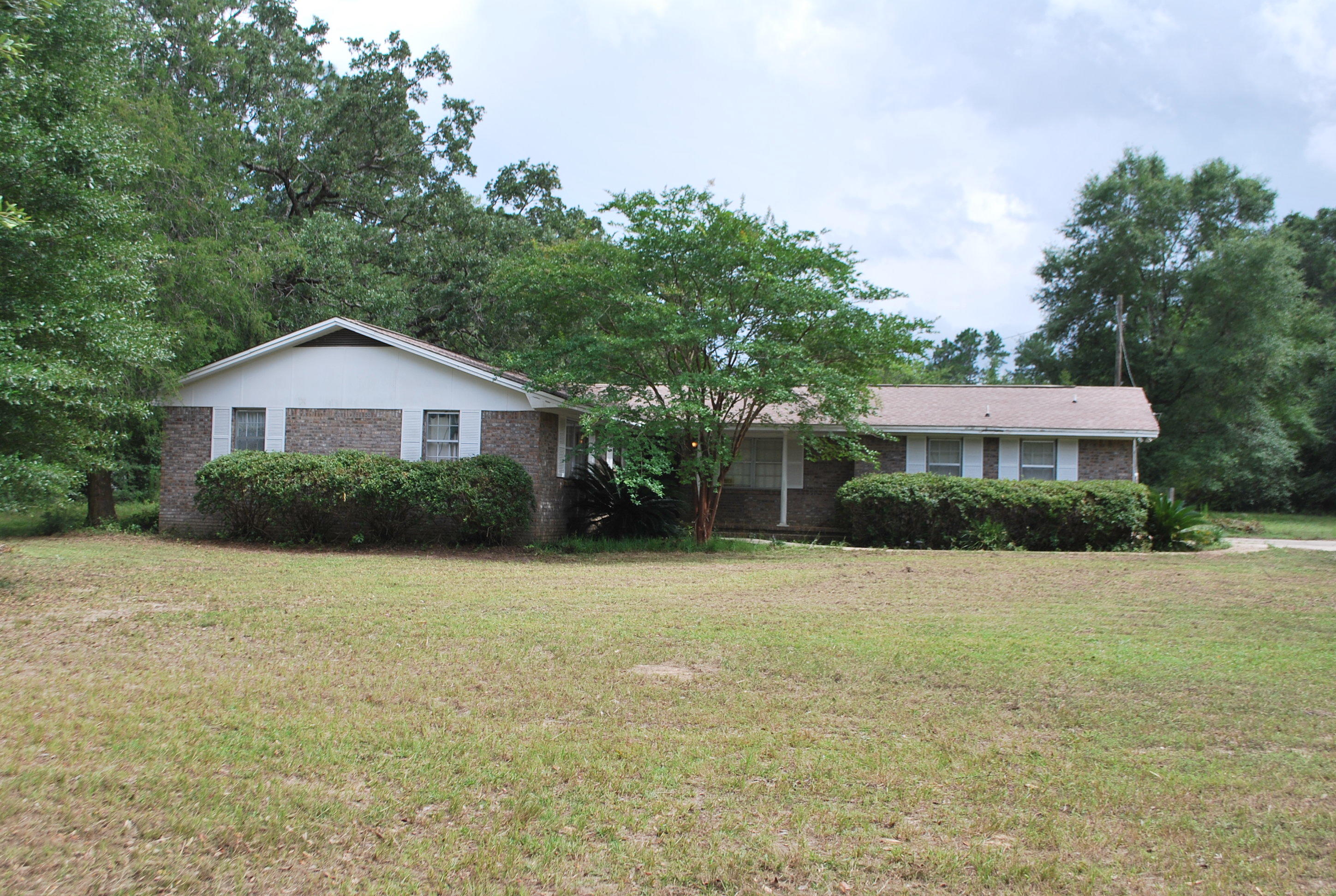 3602 Poverty Creek Road Crestview, FL 32539 - Photo 4 of 29 a front view of a house with a yard and trees