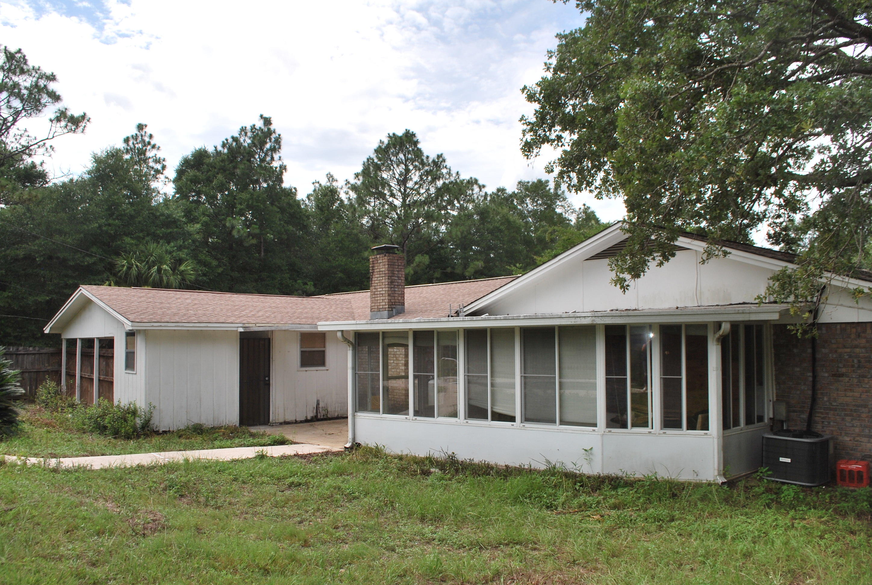 3602 Poverty Creek Road Crestview, FL 32539 - Photo 9 of 29 a view of a house with a yard and a large tree