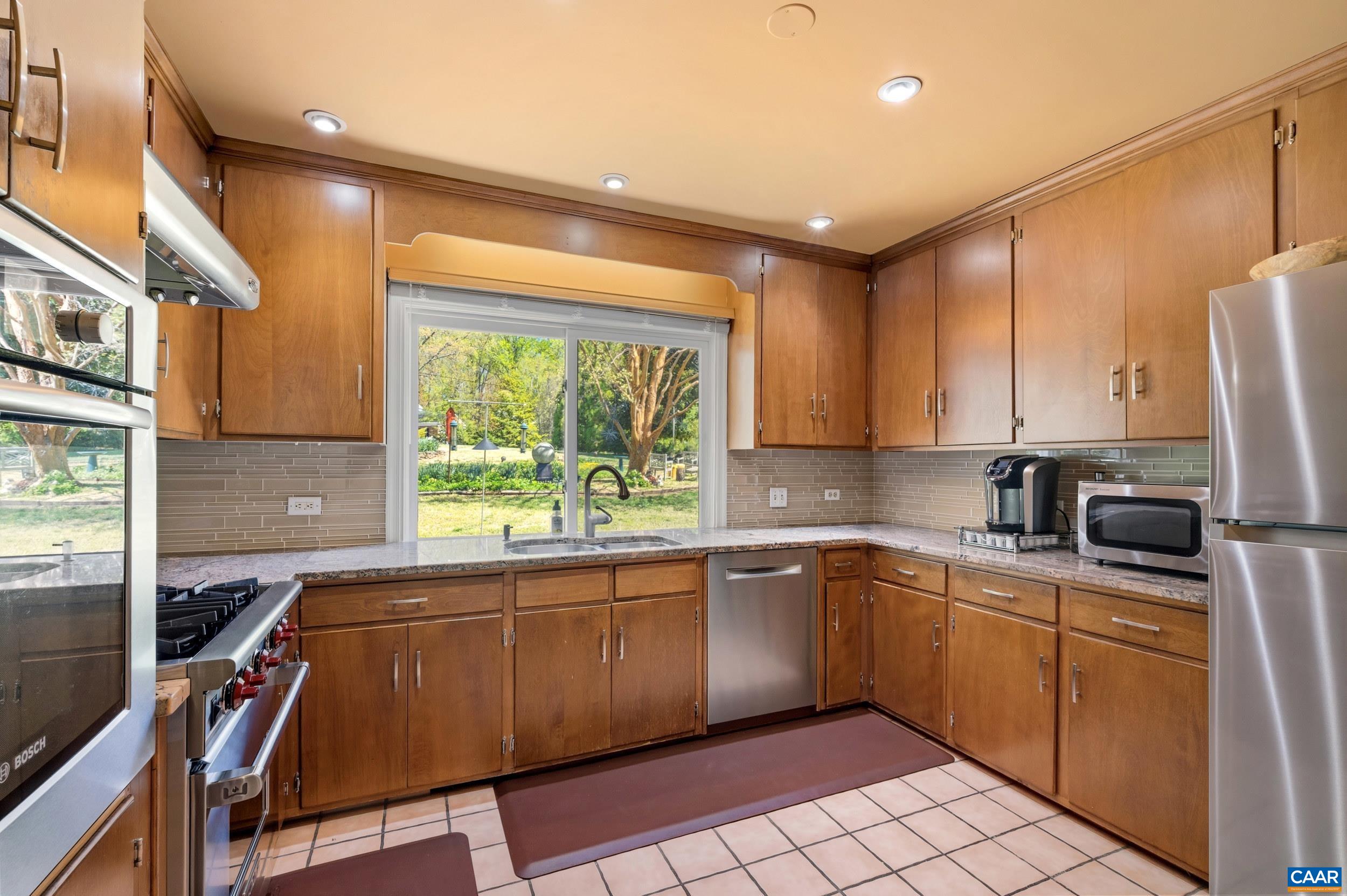 103 Powhatan Circle Charlottesville, VA 22901 - Photo 19 of 75 a kitchen with a sink appliances cabinets and a window