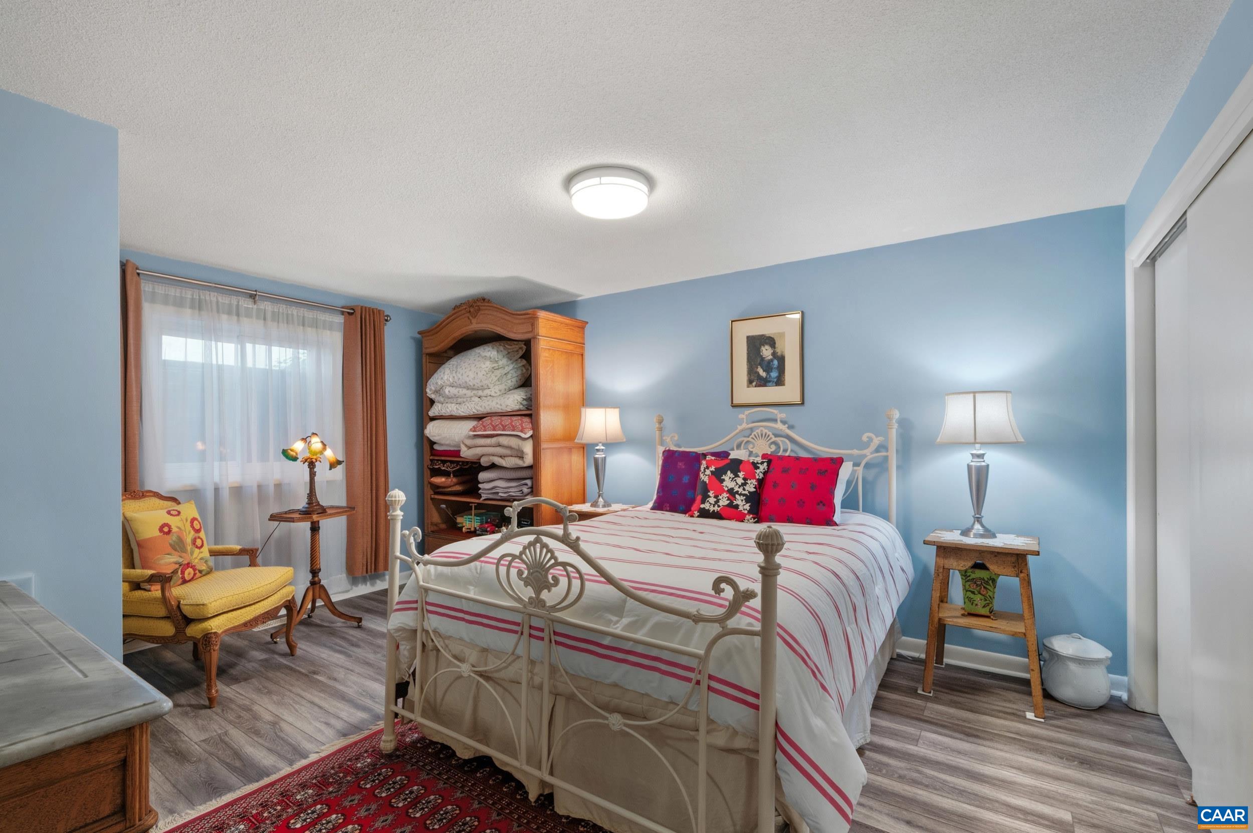 103 Powhatan Circle Charlottesville, VA 22901 - Photo 38 of 75 a bedroom with a bed and wooden floor