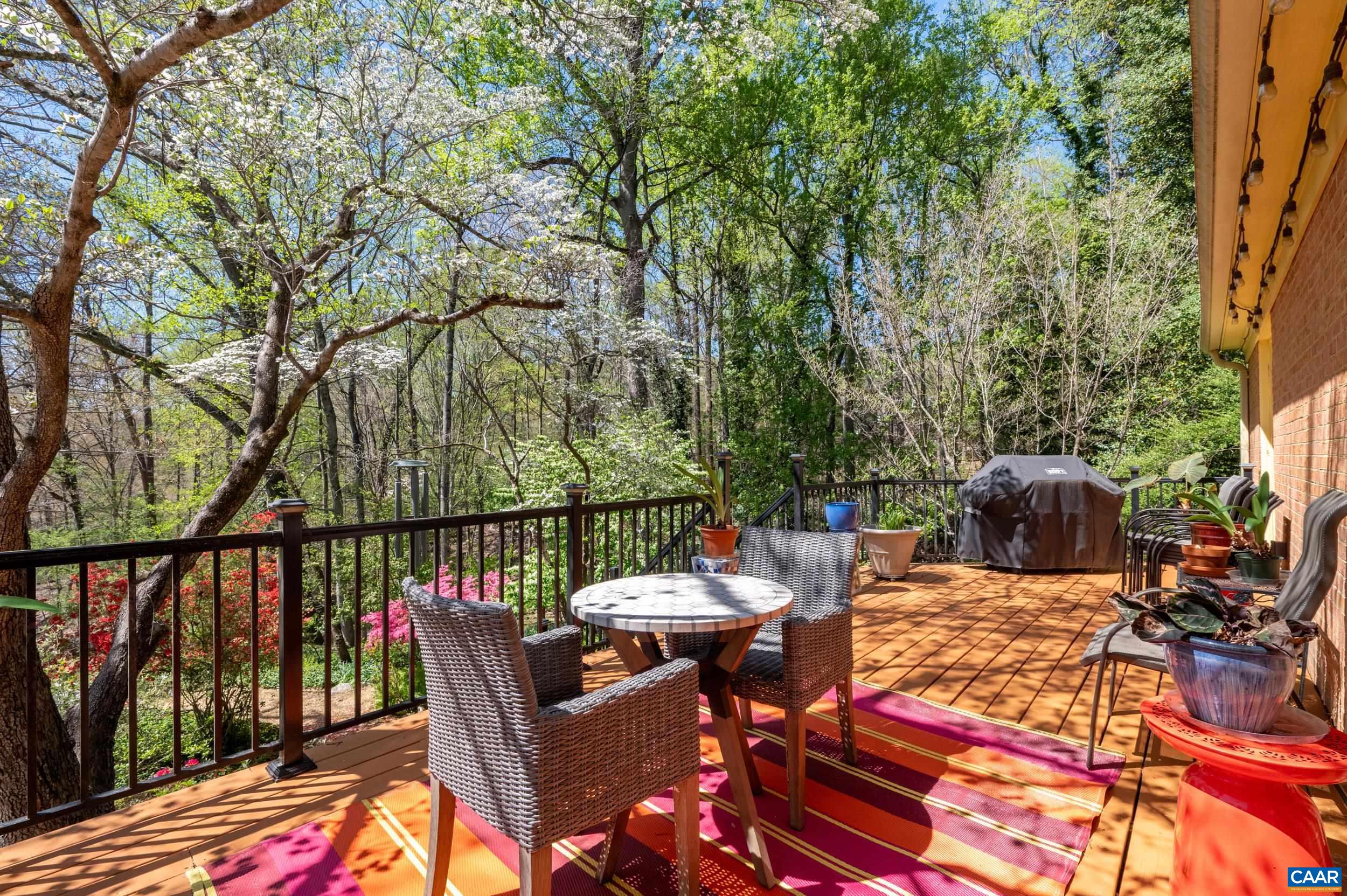 103 Powhatan Circle Charlottesville, VA 22901 - Photo 47 of 75 a view of a patio with a dining table and chairs with wooden floor and fence
