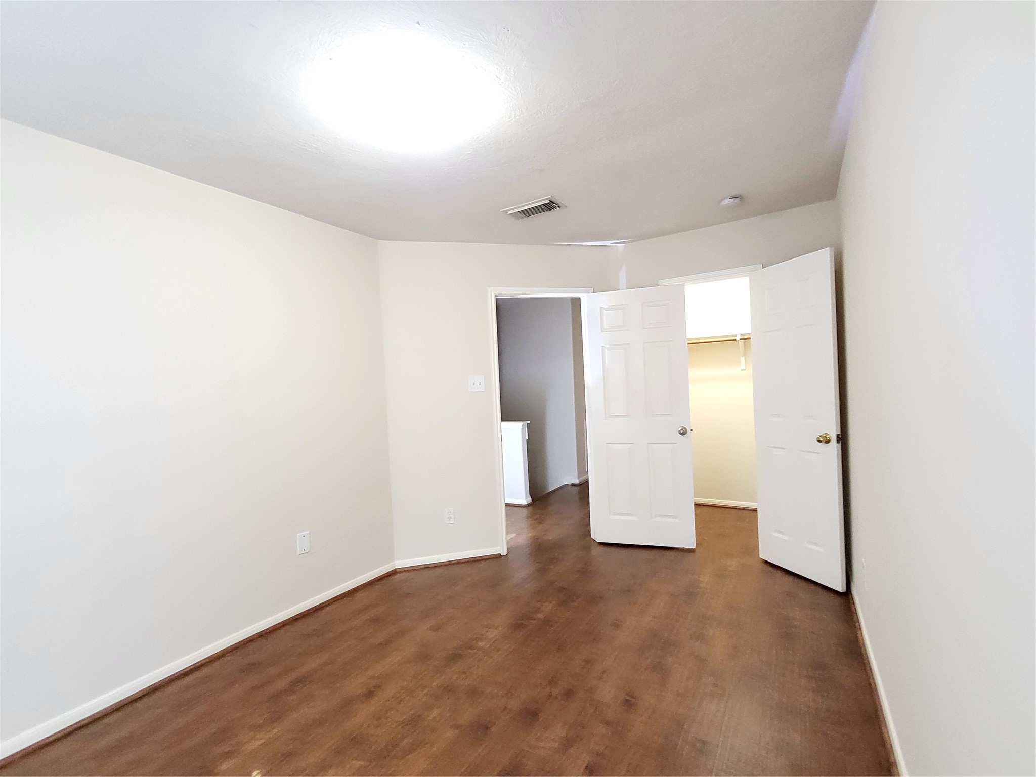 14034 Maximos Drive Houston, TX 77083 - Photo 21 of 27 a view of a big room with wooden floor and windows