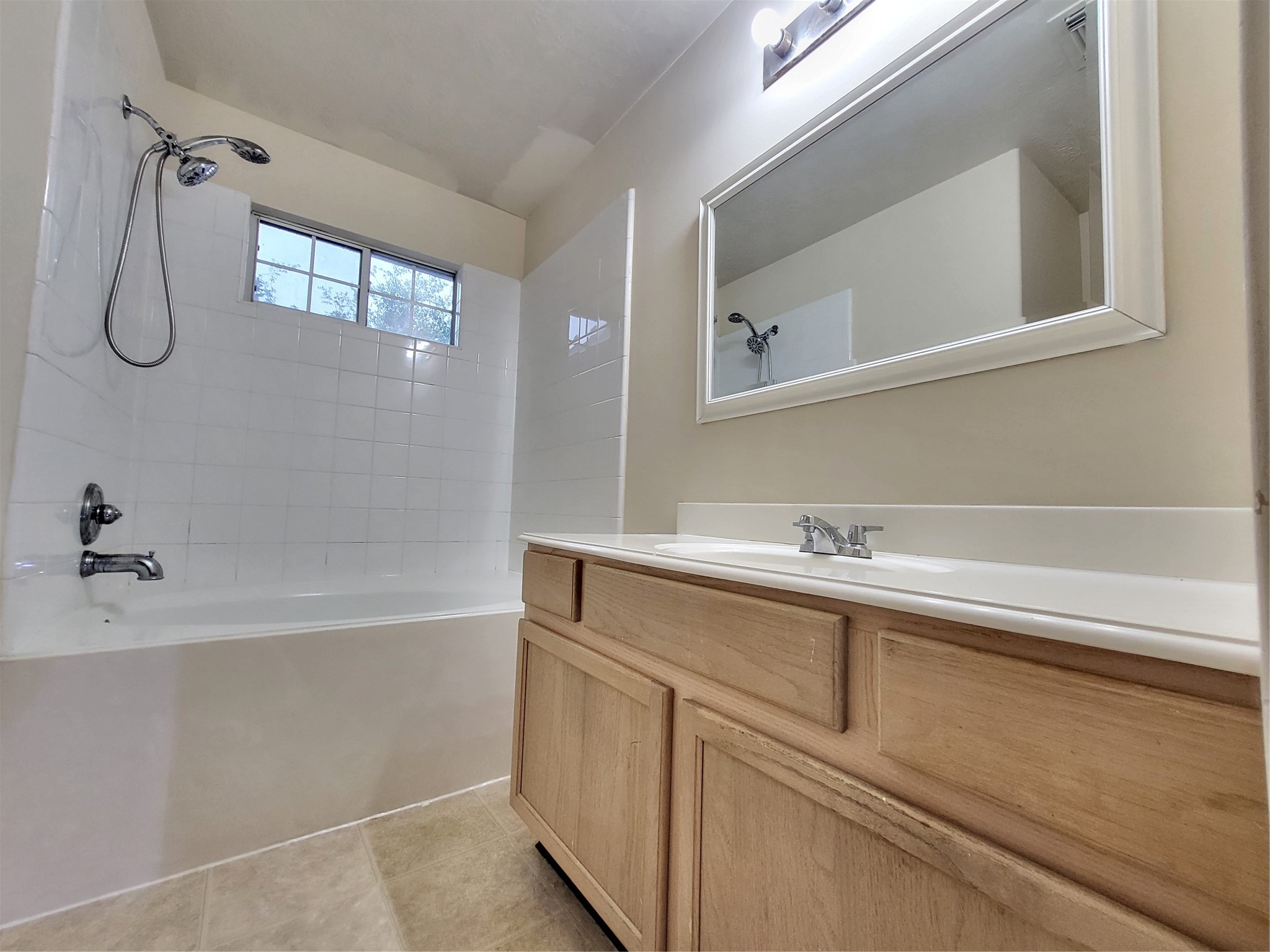 14034 Maximos Drive Houston, TX 77083 - Photo 26 of 27 a bathroom with a bathtub and a sink