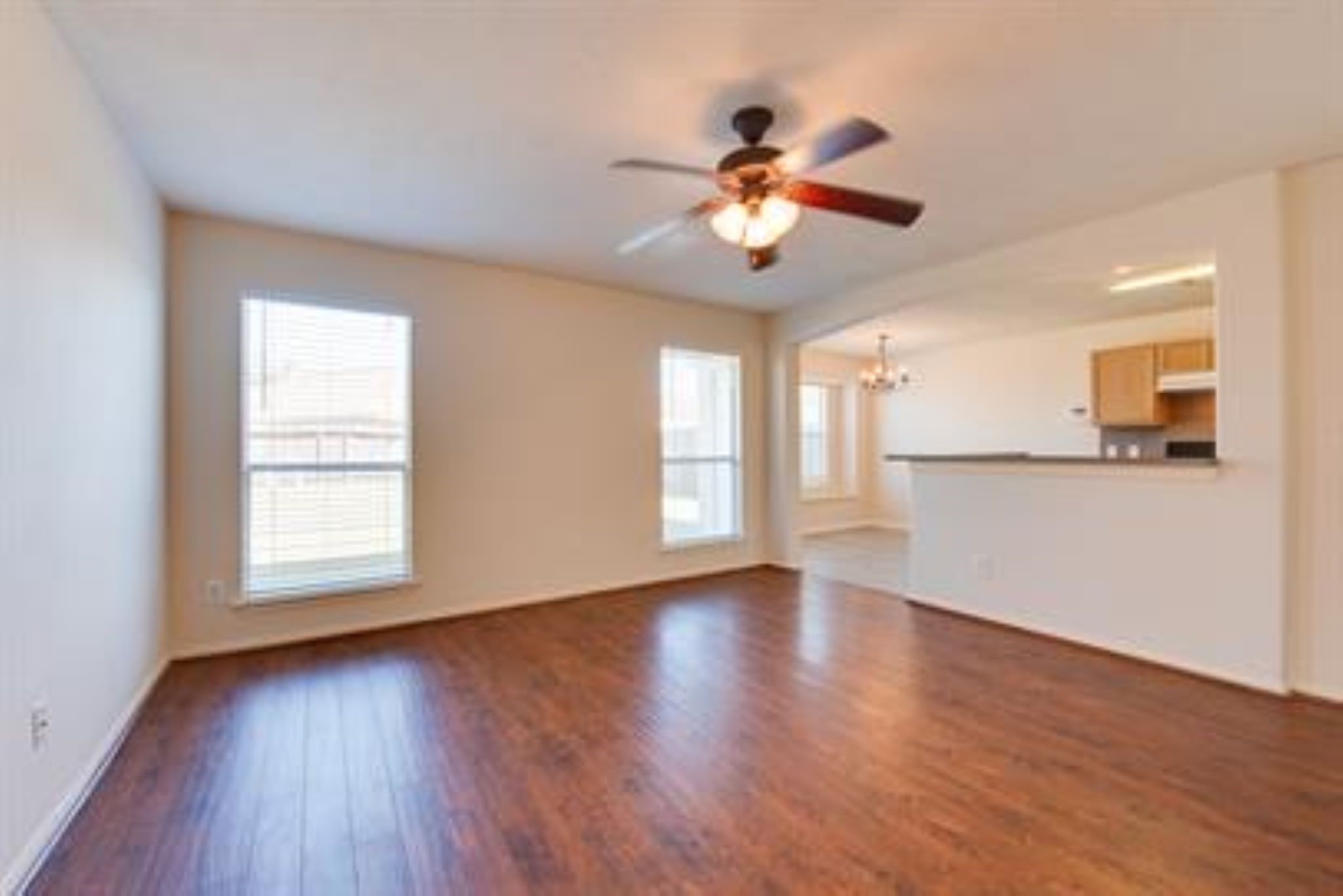 14034 Maximos Drive Houston, TX 77083 - Photo 5 of 27 a view of an empty room with a window and wooden floor