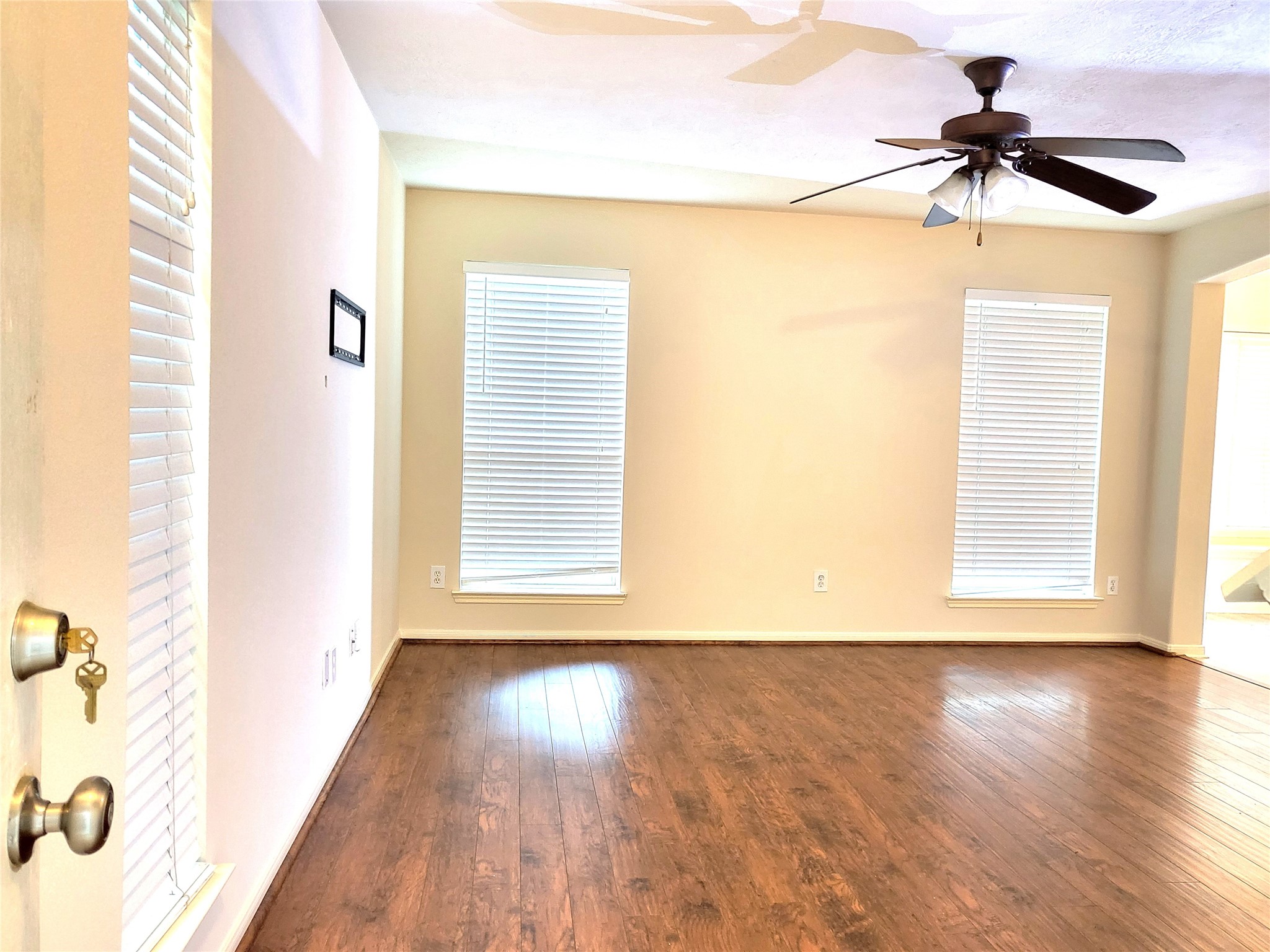 14034 Maximos Drive Houston, TX 77083 - Photo 6 of 27 a view of empty room with wooden floor and fan