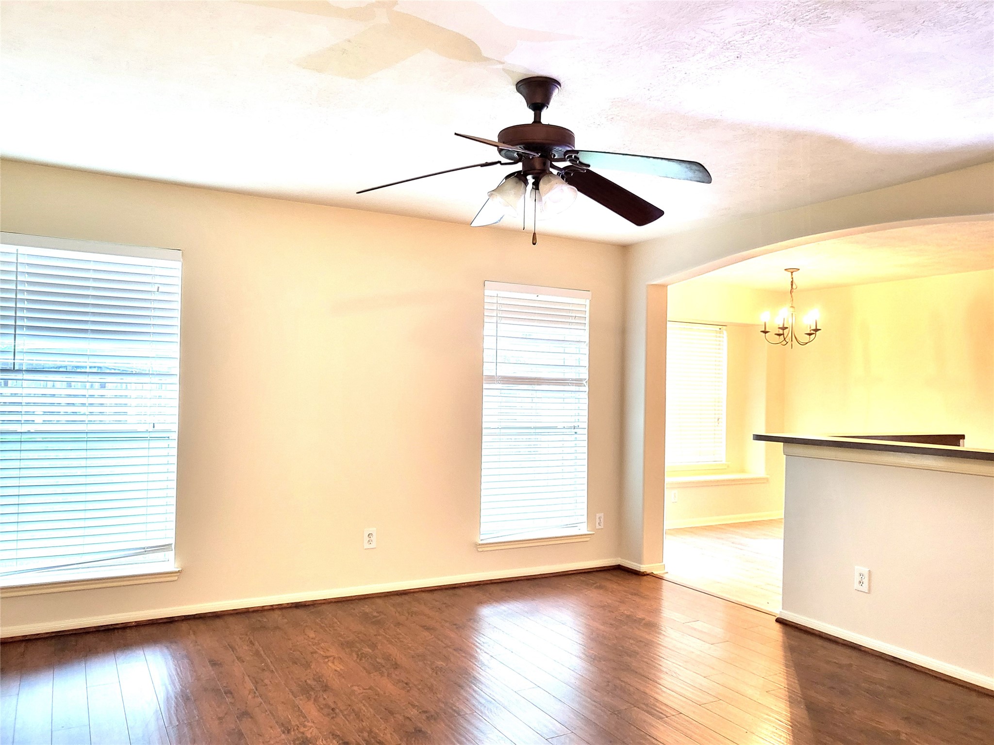 14034 Maximos Drive Houston, TX 77083 - Photo 7 of 27 a view of an empty room with wooden floor and a window