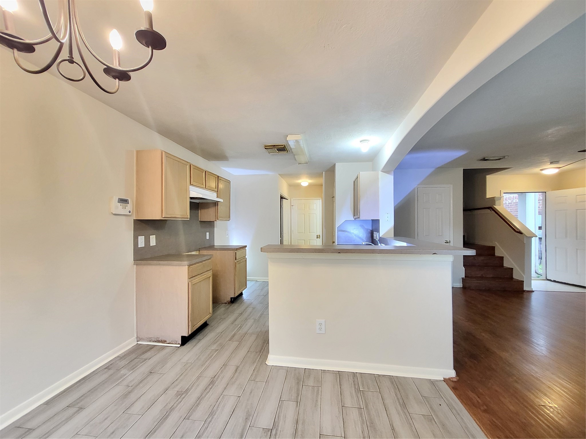 14034 Maximos Drive Houston, TX 77083 - Photo 9 of 27 a kitchen with stainless steel appliances a stove top oven a sink dishwasher and a refrigerator with wooden floor