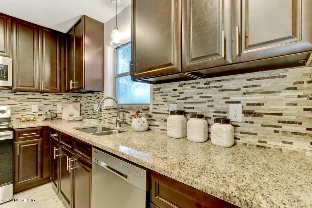 6815 Heidi Road Jacksonville, FL 32277 - Photo 13 of 36 a kitchen with a sink and cabinets
