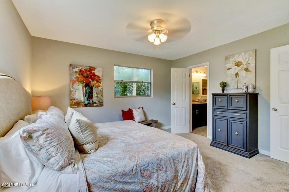 6815 Heidi Road Jacksonville, FL 32277 - Photo 22 of 36 a bed room with a bed and dresser