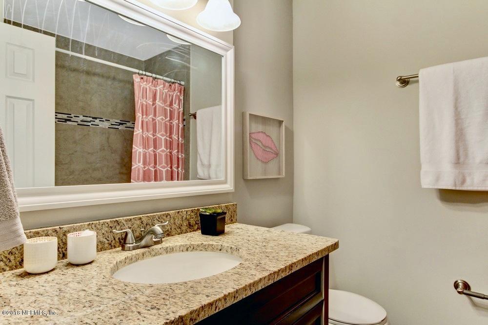 6815 Heidi Road Jacksonville, FL 32277 - Photo 30 of 36 a bathroom with a granite countertop sink and a mirror