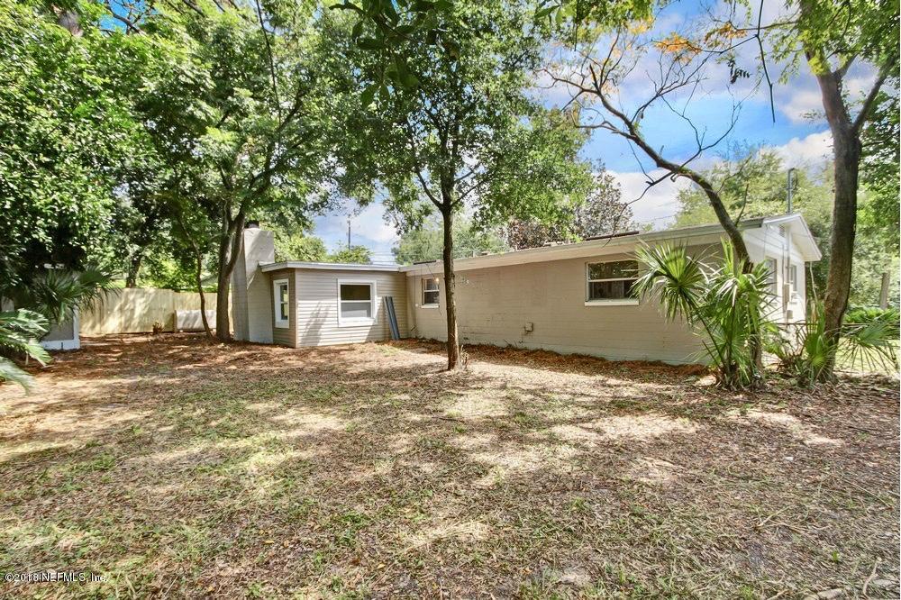 6815 Heidi Road Jacksonville, FL 32277 - Photo 34 of 36 a view of a house with a yard and garage