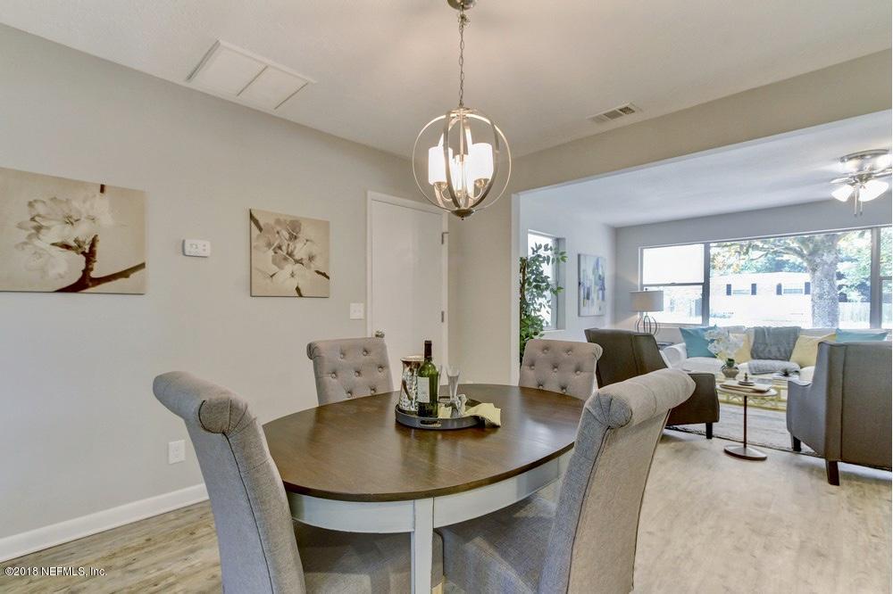 6815 Heidi Road Jacksonville, FL 32277 - Photo 7 of 36 a view of a dining room with furniture window and wooden floor