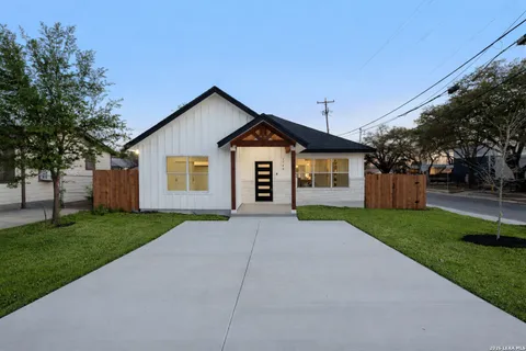 a view of a house with yard and a garden