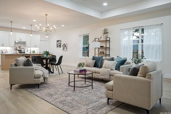 a living room with furniture and a dining table