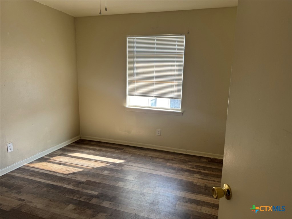 904 Houston Street Killeen, TX 76541 - Photo 12 of 17 an empty room with wooden floor and windows
