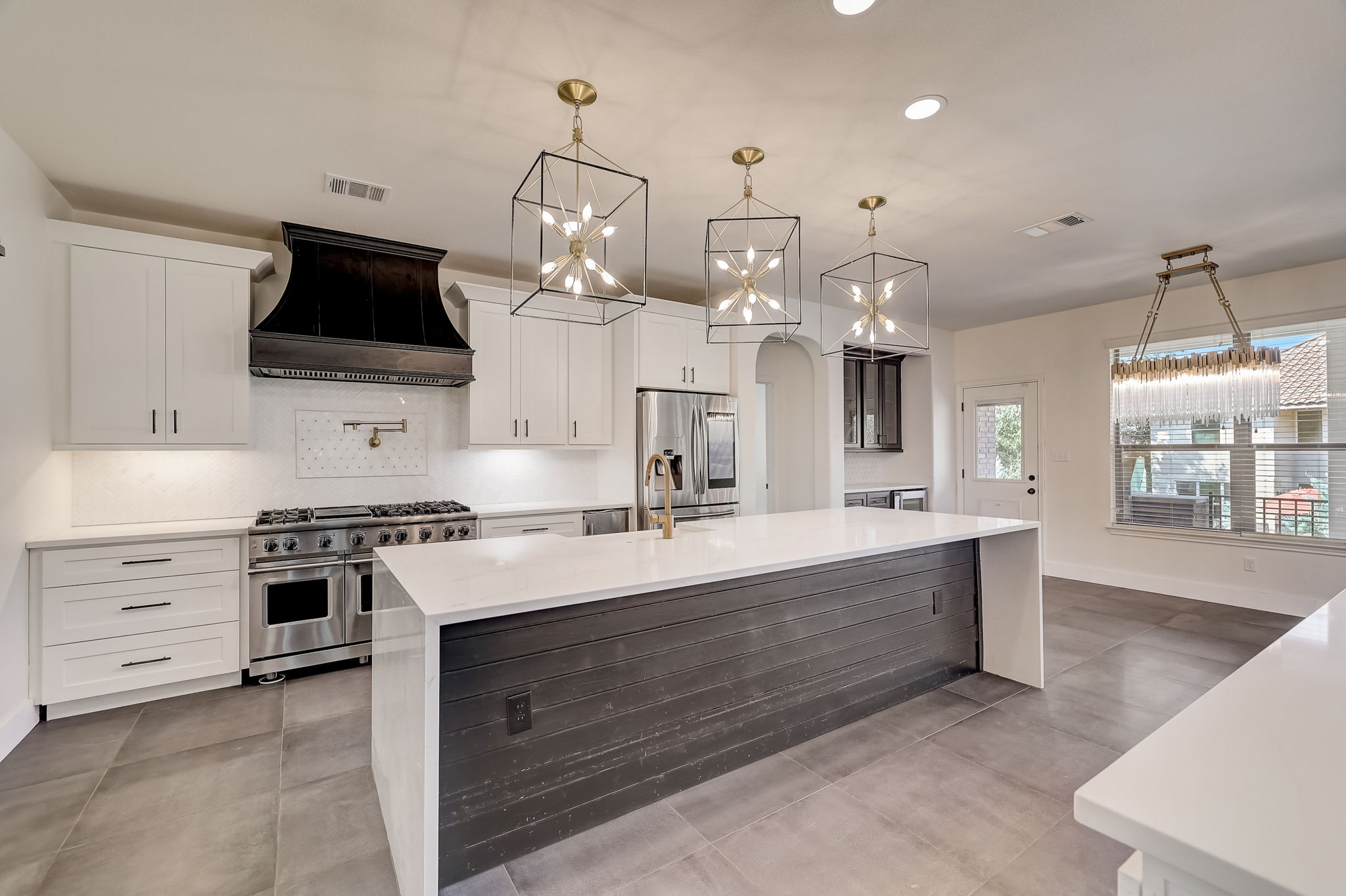 16012 Spillman Ranch Loop Austin, TX 78738 - Photo 15 of 38 Culinary dreams come alive in this well-appointed kitchen, showcasing a spacious island and top-tier appliances.