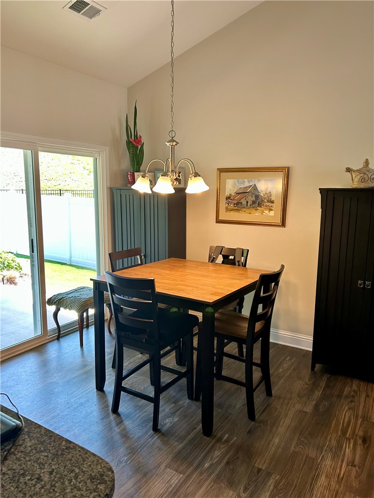 170 Capslock Trail Pendleton, SC 29670 - Photo 6 of 22 Sliding glass doors open to the yard from this dining space with rich wood flooring.