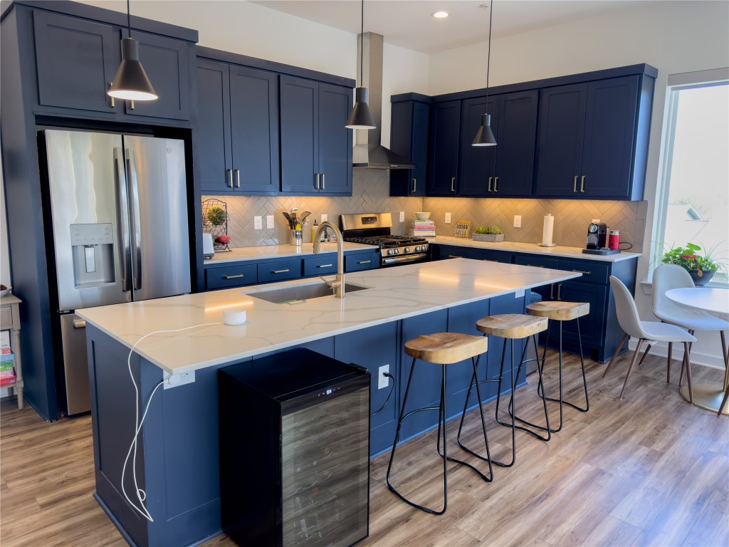 2804 South 1st Street, Unit 1301 Austin, TX 78704 - Photo 1 of 15 a kitchen with stainless steel appliances granite countertop a table chairs sink and cabinets
