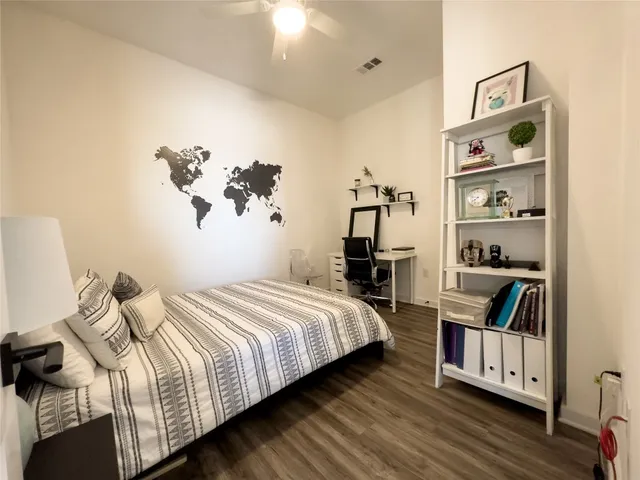 a bedroom with a bed and a book shelf