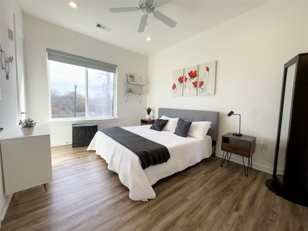 2804 South 1st Street, Unit 1301 Austin, TX 78704 - Photo 9 of 15 a spacious bedroom with a bed and a chandelier