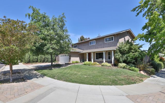 a front view of a house with a garden