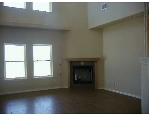a view of empty room with a fireplace