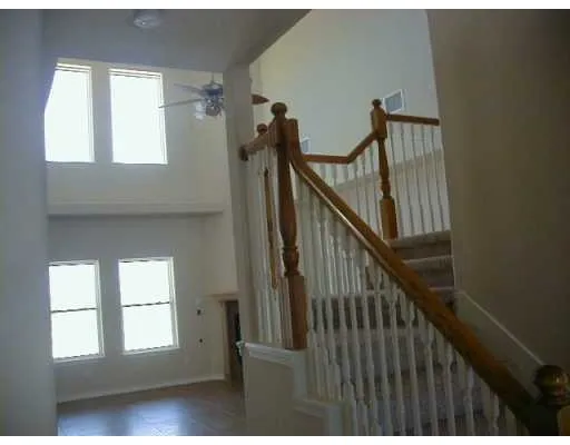 a view of staircase with railing and a window