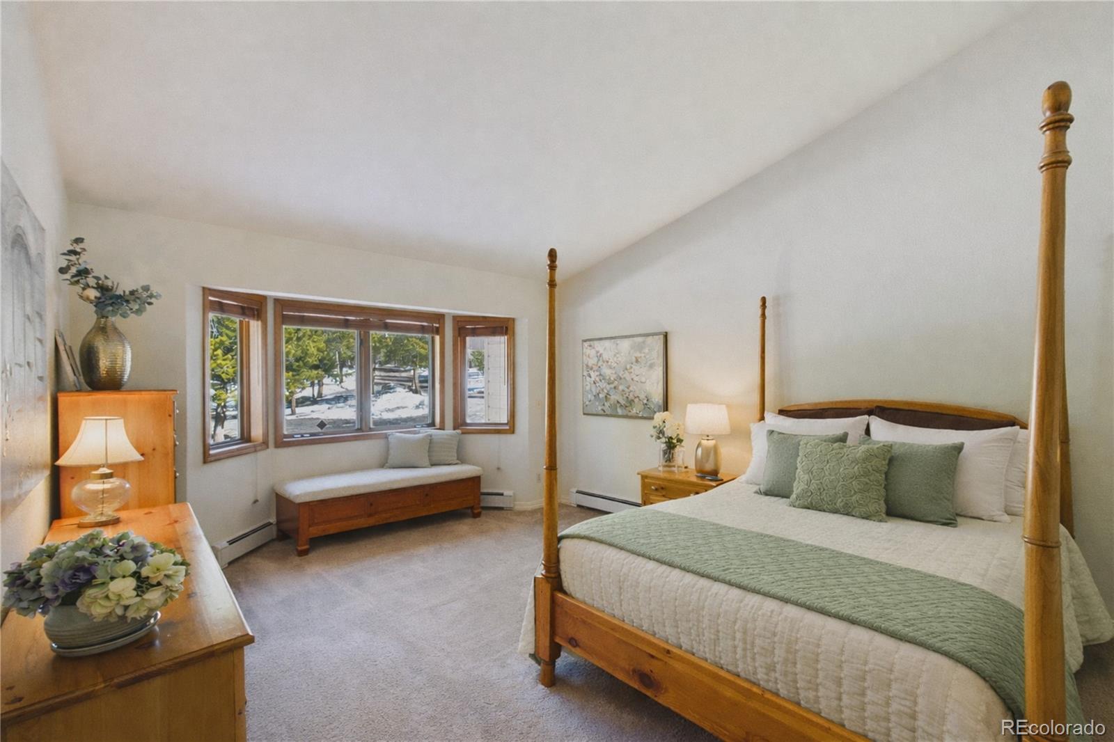 10798 Crystal Way Morrison, CO 80465 - Photo 17 of 36 a bedroom with a bed and a couch