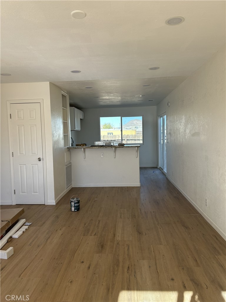15784 Wanaque Road, Unit C Apple Valley, CA 92307 - Photo 3 of 9 an empty room with wooden floor and windows