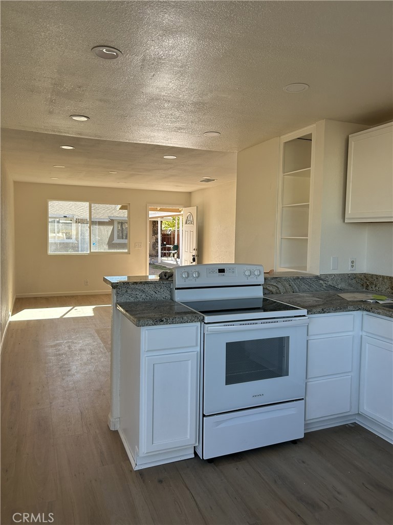 15784 Wanaque Road, Unit C Apple Valley, CA 92307 - Photo 4 of 9 a kitchen with granite countertop a sink and cabinets