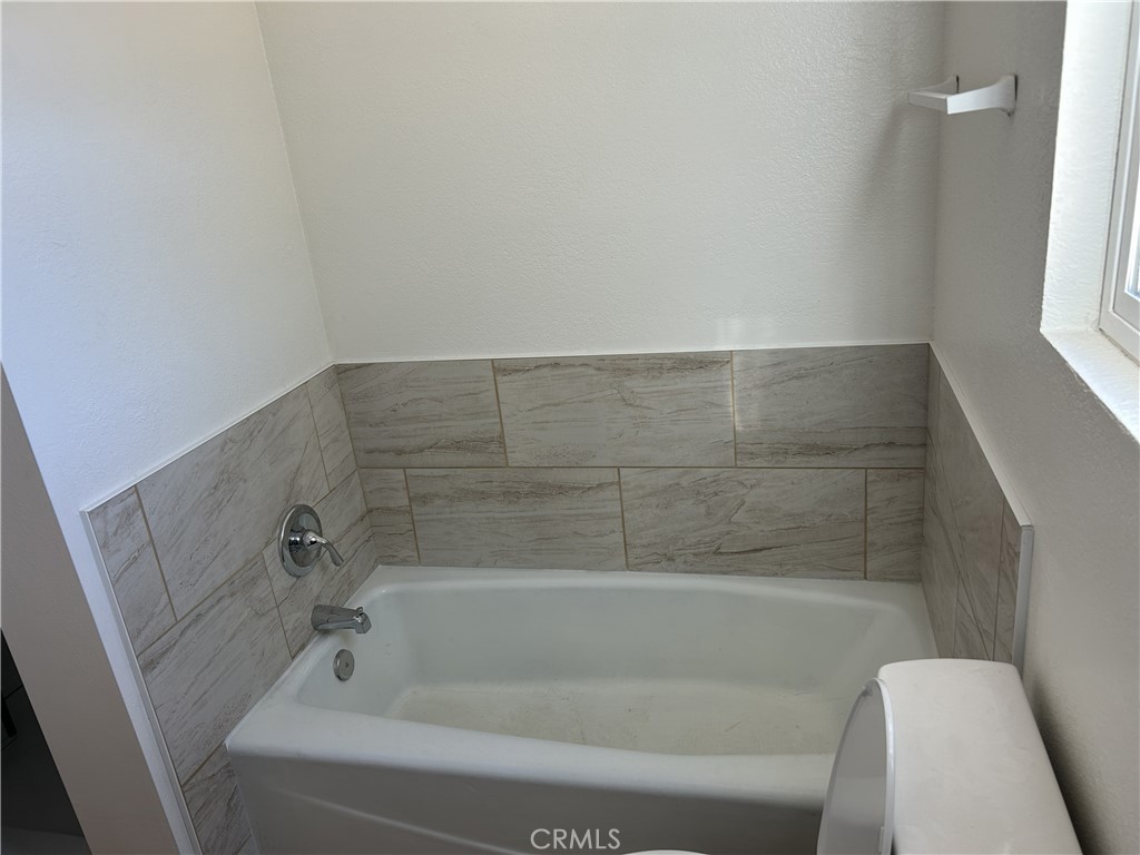 15784 Wanaque Road, Unit C Apple Valley, CA 92307 - Photo 9 of 9 a bathroom with a bathtub