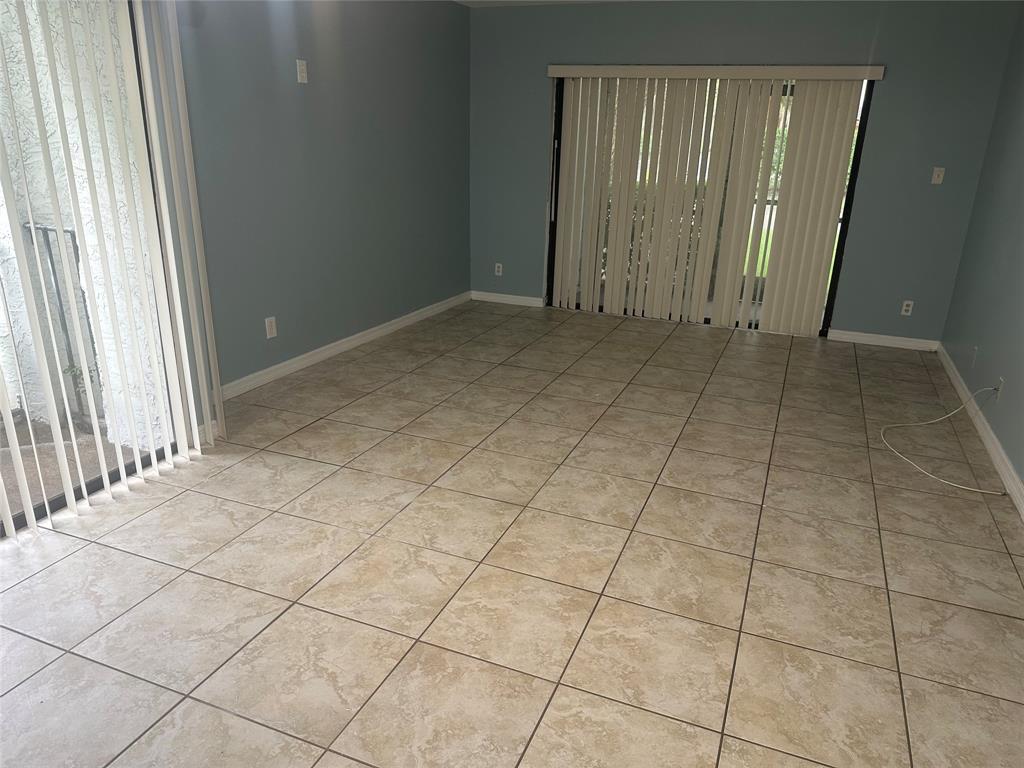 11150 West Sample Road, Unit 50 Coral Springs, FL 33065 - Photo 5 of 11 a view of a livingroom with an empty space and a window
