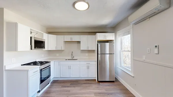 a kitchen with stainless steel appliances a refrigerator sink and microwave